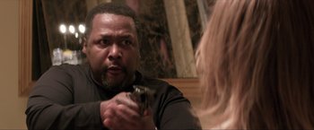 Movie still from “Parker” (2013), directed by Taylor Hackford – A man holding a gun in front of a woman; Close Up shot, Over the shoulder angle