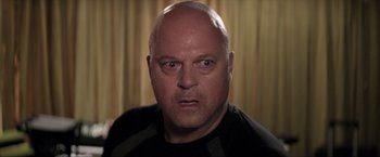 Movie still from “Parker” (2013), directed by Taylor Hackford – A man with a bald head is looking at the camera; Close Up shot, Over the shoulder angle