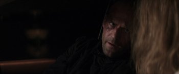 Movie still from “Parker” (2013), directed by Taylor Hackford – A person wearing a black shirt; Close Up shot, Over the shoulder angle