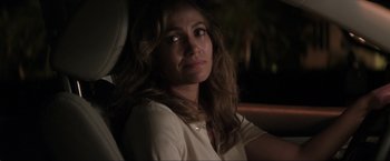 Movie still from “Parker” (2013), directed by Taylor Hackford – A woman sitting in the back seat of a car at night; Close Up shot, Over the shoulder angle