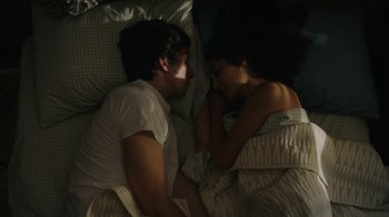 Movie still from “Paterson” (2016), directed by Jim Jarmusch – A man and a woman laying in bed together; Medium shot, Overhead angle