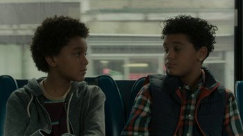 Movie still from “Paterson” (2016), directed by Jim Jarmusch – Two young boys sitting next to each other on a bus; Close Up shot, Over the shoulder angle