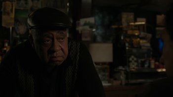 Movie still from “Paterson” (2016), directed by Jim Jarmusch – An older man wearing a hat and a sweater; Close Up shot, Over the shoulder angle
