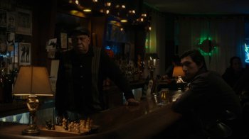 Movie still from “Paterson” (2016), directed by Jim Jarmusch – A man standing at a bar next to a man sitting at a bar; Medium shot, Over the shoulder angle