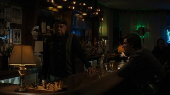 Movie still from “Paterson” (2016), directed by Jim Jarmusch – A man standing at a bar next to a man sitting at a bar; Medium shot, Over the shoulder angle
