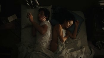 Movie still from “Paterson” (2016), directed by Jim Jarmusch – A man and a woman laying in a bed together; Medium shot, Overhead angle