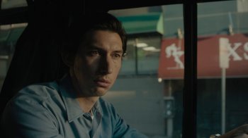 Movie still from “Paterson” (2016), directed by Jim Jarmusch – A man sitting in front of a window; Close Up shot, Low angle