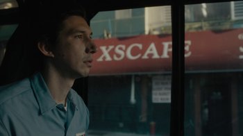 Movie still from “Paterson” (2016), directed by Jim Jarmusch – A man standing in front of a store window; Close Up shot, Low angle