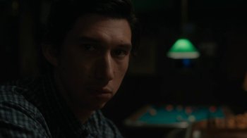 Movie still from “Paterson” (2016), directed by Jim Jarmusch – A young man stares into the camera while sitting at a pool table; Close Up shot, Over the shoulder angle