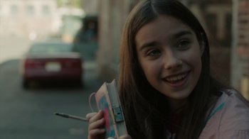 Movie still from “Paterson” (2016), directed by Jim Jarmusch – A young girl holding a book and a pencil; Close Up shot, Over the shoulder angle