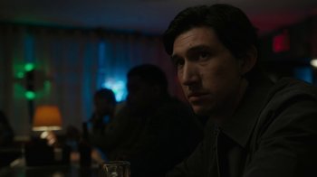 Movie still from “Paterson” (2016), directed by Jim Jarmusch – A person sitting at a table holding a glass; Close Up shot, Over the shoulder angle