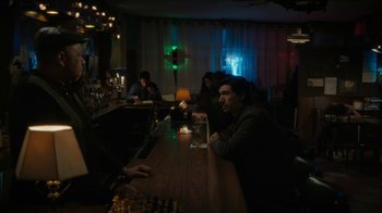 Movie still from “Paterson” (2016), directed by Jim Jarmusch – A group of people sitting at a bar; Medium shot, Over the shoulder angle