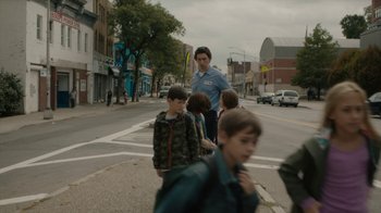 Movie still from “Paterson” (2016), directed by Jim Jarmusch – A group of children crossing a street in a city; Wide shot, Over the shoulder angle