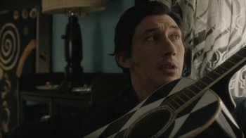Movie still from “Paterson” (2016), directed by Jim Jarmusch – A man holding a guitar in a room; Close Up shot, Over the shoulder angle