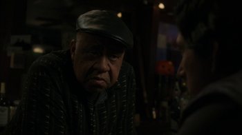 Movie still from “Paterson” (2016), directed by Jim Jarmusch – An older man wearing a hat and a striped shirt; Close Up shot, Over the shoulder angle