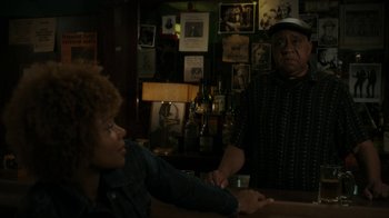 Movie still from “Paterson” (2016), directed by Jim Jarmusch – A woman sitting at a bar next to an older man; Medium shot, Over the shoulder angle