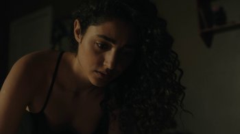 Movie still from “Paterson” (2016), directed by Jim Jarmusch – A woman with curly hair is looking down at her face; Close Up shot, Low angle