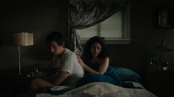 Movie still from “Paterson” (2016), directed by Jim Jarmusch – A man and a woman sitting on a bed in front of a window; Medium shot, High angle