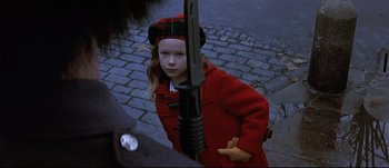 Movie still from “Patriot Games” (1992), directed by Phillip Noyce – A young girl in a red coat holding a sword; Close Up shot, Over the shoulder angle
