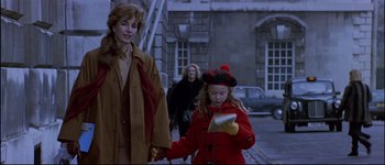 Movie still from “Patriot Games” (1992), directed by Phillip Noyce – Two women and a child walking down a street; Medium shot, Over the shoulder angle
