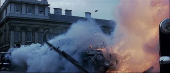 Movie still from “Patriot Games” (1992), directed by Phillip Noyce – A car is burning in the middle of the street; Wide shot, Low angle