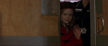Movie still from “Patriot Games” (1992), directed by Phillip Noyce – A little girl standing in a doorway waving; Close Up shot, Over the shoulder angle