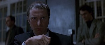 Movie still from “Patriot Games” (1992), directed by Phillip Noyce – A person wearing a suit and tie; Close Up shot, Low angle