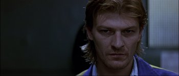 Movie still from “Patriot Games” (1992), directed by Phillip Noyce – A person with long blonde hair; Close Up shot, Low angle