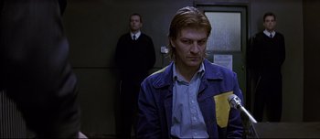 Movie still from “Patriot Games” (1992), directed by Phillip Noyce – A man in a blue jacket and a man in a black jacket; Medium shot, Over the shoulder angle