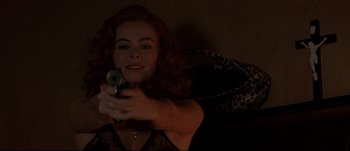 Movie still from “Patriot Games” (1992), directed by Phillip Noyce – A woman holding a gun in her hand; Close Up shot, Low angle