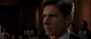 Movie still from “Patriot Games” (1992), directed by Phillip Noyce – A person wearing a suit and tie; Close Up shot, Low angle