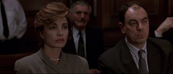 Movie still from “Patriot Games” (1992), directed by Phillip Noyce – A group of people sitting in front of each other in a room; Close Up shot, Over the shoulder angle