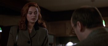 Movie still from “Patriot Games” (1992), directed by Phillip Noyce – A woman with red hair is standing next to another woman; Close Up shot, Over the shoulder angle