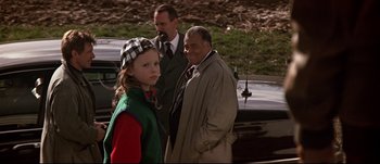 Movie still from “Patriot Games” (1992), directed by Phillip Noyce – A young girl standing next to two older men; Medium shot, Over the shoulder angle