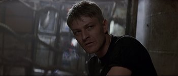 Movie still from “Patriot Games” (1992), directed by Phillip Noyce – A person wearing a black t - shirt; Close Up shot, Low angle