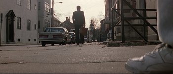 Movie still from “Patriot Games” (1992), directed by Phillip Noyce – A man walking down a street holding a briefcase; Extreme Wide shot, High angle