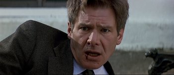 Movie still from “Patriot Games” (1992), directed by Phillip Noyce – A person wearing a suit and tie; Close Up shot, Low angle