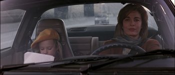 Movie still from “Patriot Games” (1992), directed by Phillip Noyce – Two people in a car looking out of the window; Medium shot, High angle