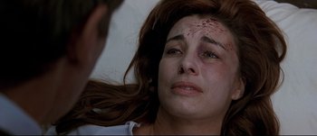 Movie still from “Patriot Games” (1992), directed by Phillip Noyce – A person with blood all over her face; Close Up shot, Over the shoulder angle