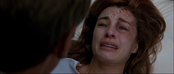 Movie still from “Patriot Games” (1992), directed by Phillip Noyce – A person crying with blood all over her face; Close Up shot, Low angle