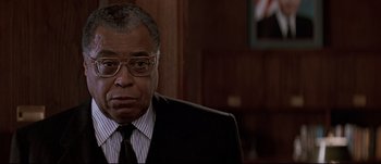 Movie still from “Patriot Games” (1992), directed by Phillip Noyce – An older man wearing a suit and tie; Close Up shot, Low angle