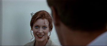 Movie still from “Patriot Games” (1992), directed by Phillip Noyce – A person looking in a mirror; Close Up shot, Over the shoulder angle