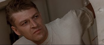 Movie still from “Patriot Games” (1992), directed by Phillip Noyce – A person wearing a white t - shirt; Close Up shot, Low angle