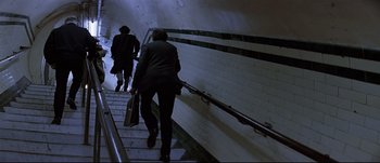 Movie still from “Patriot Games” (1992), directed by Phillip Noyce – Two people walking up a flight of stairs; Wide shot, High angle