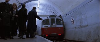 Movie still from “Patriot Games” (1992), directed by Phillip Noyce – A man standing in front of a subway train; Wide shot, High angle