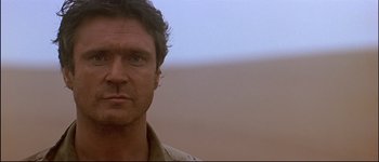 Movie still from “Patriot Games” (1992), directed by Phillip Noyce – A man's face in the desert; Close Up shot, Low angle