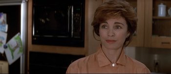 Movie still from “Patriot Games” (1992), directed by Phillip Noyce – A person wearing an orange shirt; Close Up shot, Over the shoulder angle