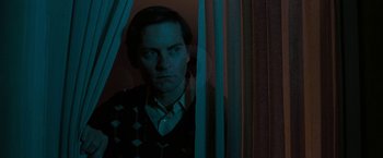 Movie still from “Pawn Sacrifice” (2014), directed by Edward Zwick – A man standing in front of a curtain; Medium shot, Low angle