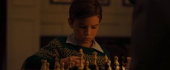 Movie still from “Pawn Sacrifice” (2014), directed by Edward Zwick – A young boy playing a game of chess; Close Up shot, High angle