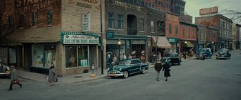 Movie still from “Pawn Sacrifice” (2014), directed by Edward Zwick – An old car parked on the side of the street; Extreme Wide shot, High angle